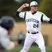 Eastern Michigan pitcher Jordan Glover looks to throw to first base for an out against Michigan at Eastern on Wednesday.  Melanie Maxwell I AnnArbor.com